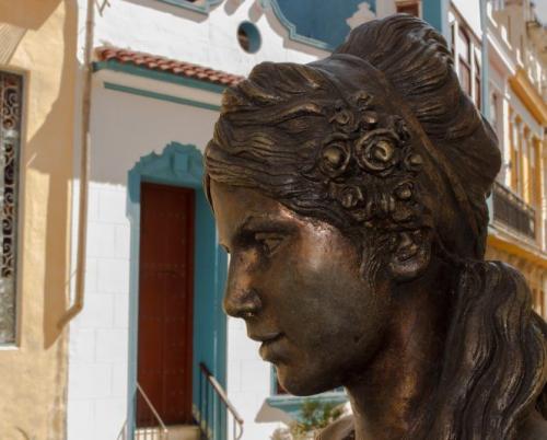 The bronze little Virgin still walks through Havana